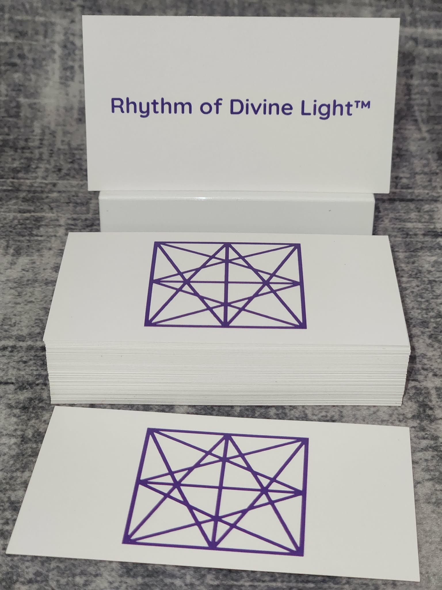 Hands holding the HAMI's Light™ sigil in soft radiant light
